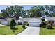 Charming single-story home boasts a well-manicured lawn and a decorative driveway at 2482 Ansley Path, The Villages, FL 32162