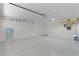 Spacious garage with epoxy flooring, ample lighting, and plenty of room for parking and storage at 2482 Ansley Path, The Villages, FL 32162
