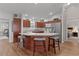 Well-lit kitchen featuring an island with seating, stainless steel appliances, and ample cabinet space at 2482 Ansley Path, The Villages, FL 32162