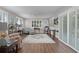 Spacious living room with hardwood flooring, large windows, and comfortable seating at 2482 Ansley Path, The Villages, FL 32162