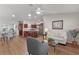 Open-concept living space with wood floors, kitchen island, and dining area at 2482 Ansley Path, The Villages, FL 32162