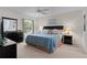 Cozy main bedroom features neutral walls, large window, ceiling fan, and complementary furnishings at 2482 Ansley Path, The Villages, FL 32162