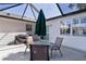 Covered patio with outdoor table and chairs, an umbrella, and a grill, ideal for entertaining at 2482 Ansley Path, The Villages, FL 32162