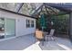 Patio area with a table, chairs, and screen enclosure overlooking a garden and surrounding nature at 2482 Ansley Path, The Villages, FL 32162