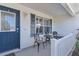 Cozy front porch with seating area, perfect for relaxing and enjoying the neighborhood at 2482 Ansley Path, The Villages, FL 32162