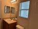 Bright bathroom with a large mirror, a tiled shower, and ample lighting at 25801 Belle Helene, Leesburg, FL 34748