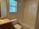 Full bathroom with tiled shower-tub combo and single sink vanity at 25801 Belle Helene, Leesburg, FL 34748