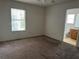 Spacious carpeted bedroom, naturally lit from the window, leads into an en-suite bathroom at 25801 Belle Helene, Leesburg, FL 34748