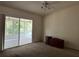 Bedroom with a ceiling fan and sliding doors to an outdoor patio at 25801 Belle Helene, Leesburg, FL 34748