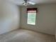 This carpeted bedroom has a ceiling fan and one window with blinds at 25801 Belle Helene, Leesburg, FL 34748