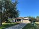 Charming single-story home featuring a cozy screened porch, attached garage, and well-maintained front lawn at 25801 Belle Helene, Leesburg, FL 34748