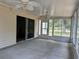 Enclosed sunroom with concrete flooring, ceiling fans, and sliding door access at 25801 Belle Helene, Leesburg, FL 34748