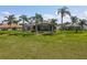 Expansive backyard with lush green grass and screened-in pool provides ample space for recreation at 27027 Old English Ct, Leesburg, FL 34748