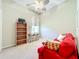 Bright bedroom with cozy seating and views at 27027 Old English Ct, Leesburg, FL 34748