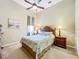Bright bedroom featuring a ceiling fan, a comfortable queen-sized bed, and calming wall art at 27027 Old English Ct, Leesburg, FL 34748