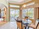 Inviting breakfast nook with glass table and chairs, with a view of the pool area at 27027 Old English Ct, Leesburg, FL 34748