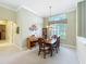 Dining room showcases a grand window, elegant table, and light-colored walls at 27027 Old English Ct, Leesburg, FL 34748