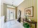 Elegant foyer features leaded glass door, neutral tile flooring, and tasteful decor at 27027 Old English Ct, Leesburg, FL 34748