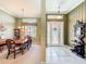 Open floor plan showcasing the dining area, foyer, and front door, creating an inviting living space at 27027 Old English Ct, Leesburg, FL 34748