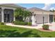 Charming home with well-maintained landscaping, including green shrubs and colorful flowerbeds framing the entrance at 27027 Old English Ct, Leesburg, FL 34748