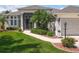 Beautiful home featuring a manicured lawn, decorative landscaping, and a welcoming walkway leading to the front door at 27027 Old English Ct, Leesburg, FL 34748