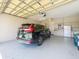 Spacious two car garage with extra refrigerator and freezer at 27027 Old English Ct, Leesburg, FL 34748
