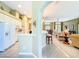 Open-concept kitchen with white cabinets and a view into the living area at 27027 Old English Ct, Leesburg, FL 34748
