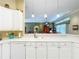Bright kitchen view featuring white cabinets and pendant lighting at 27027 Old English Ct, Leesburg, FL 34748