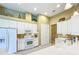 Bright kitchen featuring white cabinets and appliances at 27027 Old English Ct, Leesburg, FL 34748