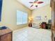Office room with neutral walls, tile flooring, and comfortable seating area at 27027 Old English Ct, Leesburg, FL 34748