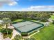 Scenic aerial shot of the tennis courts with surrounding greenery and landscaping, offering an active lifestyle at 27027 Old English Ct, Leesburg, FL 34748