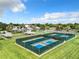 Overhead view of the community tennis and pickleball courts with the clubhouse in the background in a well-maintained facility at 27027 Old English Ct, Leesburg, FL 34748