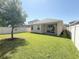 Expansive backyard with a lush green lawn and privacy fence is perfect for outdoor activities and relaxation at 2721 Picasso Ct, Kissimmee, FL 34743