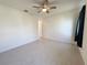 Neutral bedroom featuring a ceiling fan, tiled floors, and an attached closet at 2721 Picasso Ct, Kissimmee, FL 34743