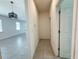 Hallway leading to dining area with a light fixture and connecting doors to the rest of the home at 2721 Picasso Ct, Kissimmee, FL 34743
