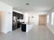 Bright, open kitchen featuring a large island, stainless steel appliances, and sleek black cabinetry at 2721 Picasso Ct, Kissimmee, FL 34743