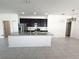 Bright kitchen area with large island, modern stainless appliances, and overhead lighting at 2721 Picasso Ct, Kissimmee, FL 34743