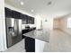 Bright kitchen features modern stainless steel appliances, granite countertops and sleek black cabinetry at 2721 Picasso Ct, Kissimmee, FL 34743