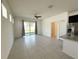 Bright, open-concept living and kitchen area with neutral tones and large sliding glass doors at 2721 Picasso Ct, Kissimmee, FL 34743