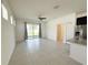 Open-concept living room with sliding glass doors to the backyard and modern stainless steel appliances at 2721 Picasso Ct, Kissimmee, FL 34743