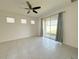 Bright living room with tiled floors, a ceiling fan, and sliding glass doors to the backyard at 2721 Picasso Ct, Kissimmee, FL 34743
