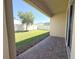 Covered patio overlooks a well-manicured lawn and a shade tree, ideal for outdoor dining or entertaining at 2721 Picasso Ct, Kissimmee, FL 34743