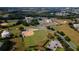 Aerial shot showcasing a softball field, clubhouse, and the property's expansive green space at 27510 Discover Ct, Leesburg, FL 34748