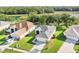 Aerial view of a home featuring a well-maintained lawn and landscaping with a lake and wooded area nearby at 27510 Discover Ct, Leesburg, FL 34748