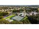 An aerial view of the neighborhood pool, clubhouse, tennis court, and meticulously landscaped grounds at 27510 Discover Ct, Leesburg, FL 34748