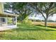Exterior shot of an enclosed sunroom with large backyard and scenic views at 27510 Discover Ct, Leesburg, FL 34748