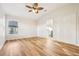 Bedroom with wood floors, a ceiling fan, and an ensuite bathroom at 27510 Discover Ct, Leesburg, FL 34748