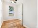 Bedroom featuring wood floors, a ceiling fan, and a window at 27510 Discover Ct, Leesburg, FL 34748