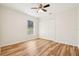 Bedroom showcasing wood floors, ceiling fan, window, and a closet with bi-fold doors at 27510 Discover Ct, Leesburg, FL 34748