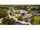 Aerial view of the clubhouse featuring lush landscaping, sidewalks, and palm trees at 27510 Discover Ct, Leesburg, FL 34748